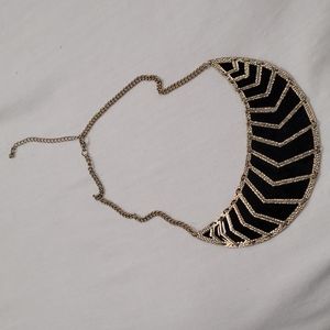 Black and gold coloured segmented necklace.